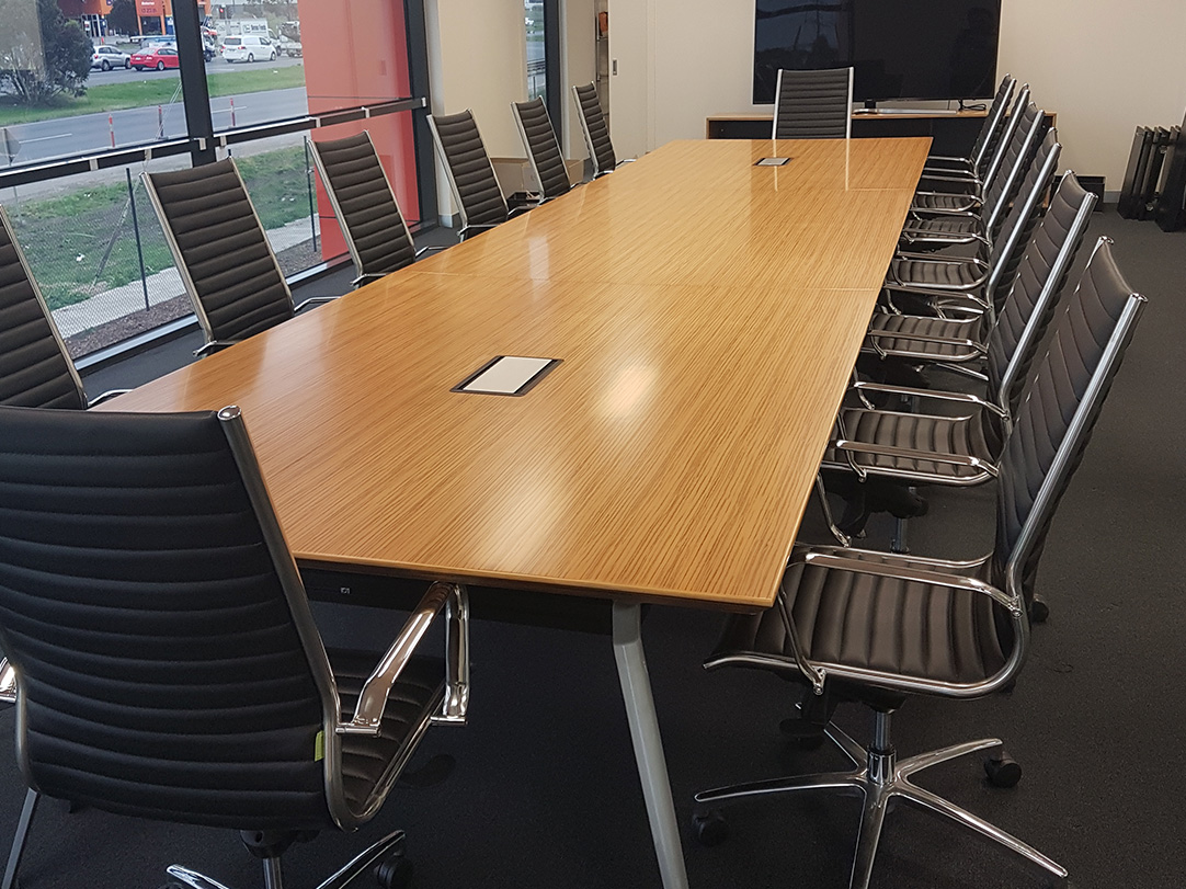 Physics boardroom table with veneer top and metal legs in a boardroom setting
