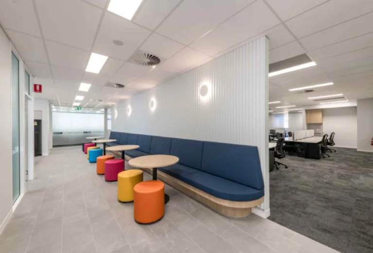 Commercial dining chairs and tables for office cafeteria and breakout area seating.