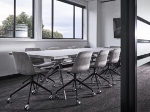 Office meeting table with black frame and wood top for conference and collaborative workspace use
