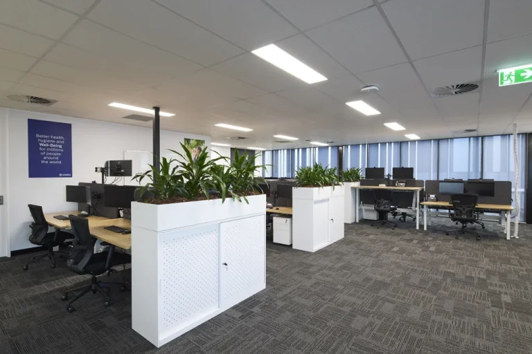 Open-plan office furniture with modular seating, desks, task chairs, and collaborative workstations
